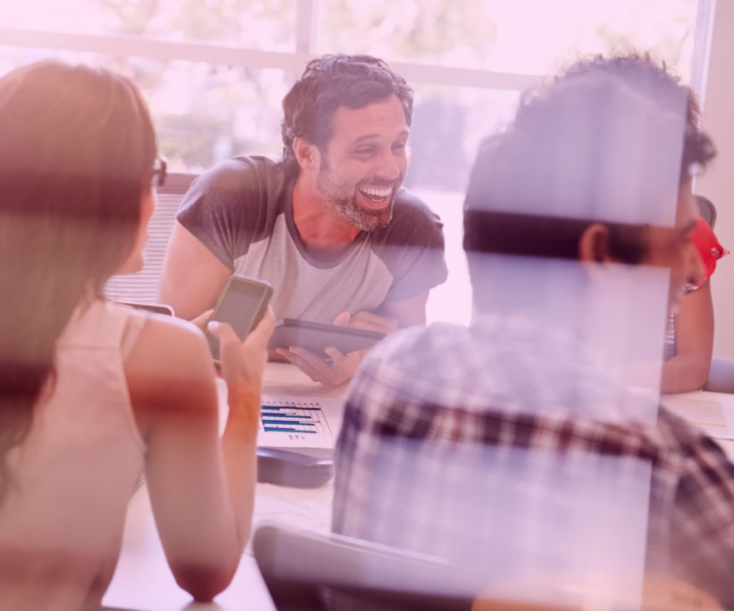 Team collaborating in a digital marketing strategy meeting using devices and data insights